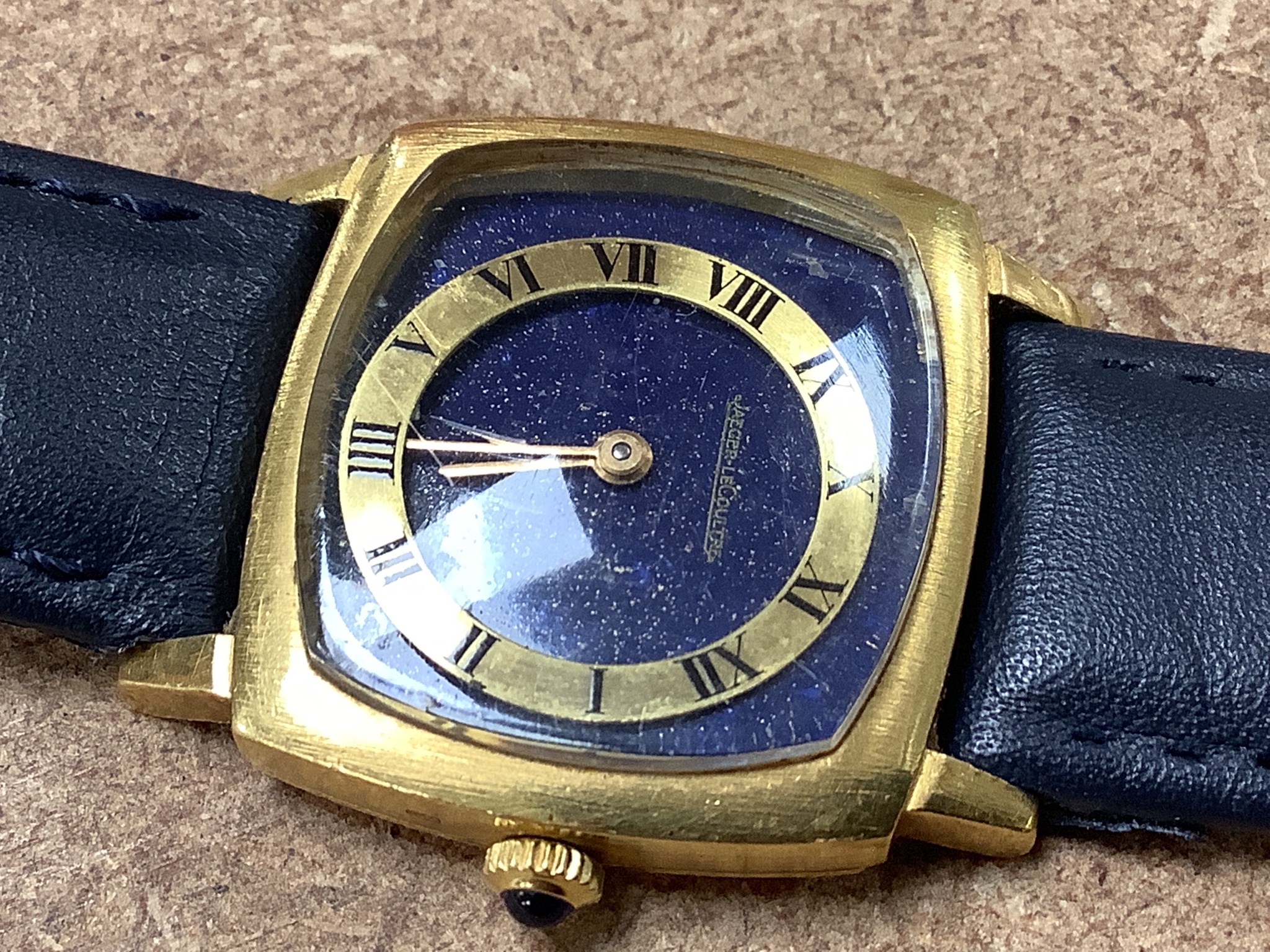 A lady's? 18k yellow metal Jaeger LeCoultre manual wind dress wrist watch with lapis lazuli dial (with loose Roman chapter ring), case diameter 29mm, gross weight29.7 grams.